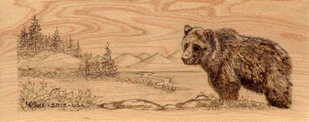 Pyrography of bear in a mountain range